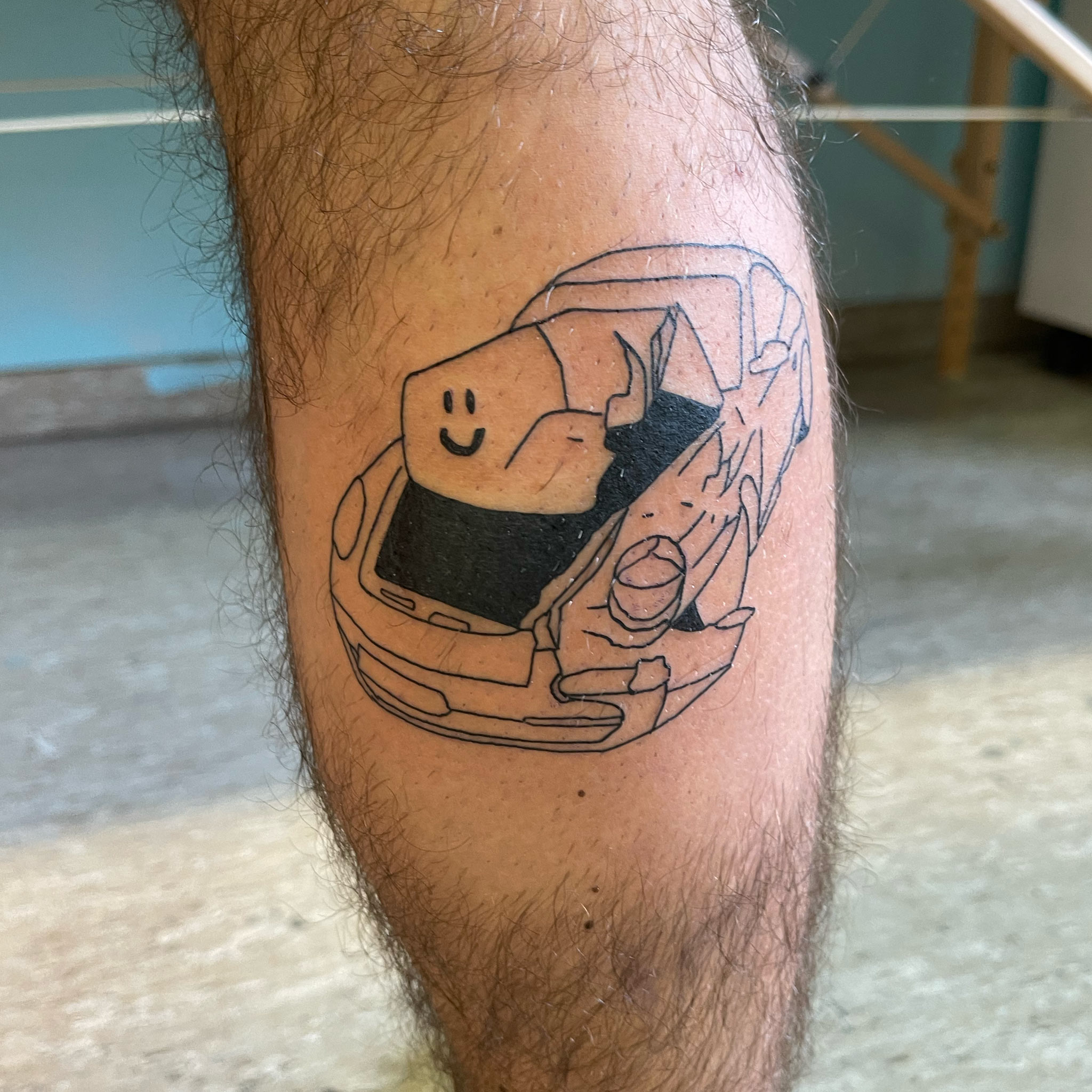 A crashed car with a smiley on a calf